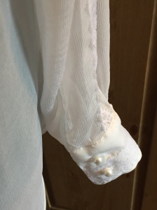 Cuff detail with appliqued lace and pearl buttons